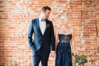 08 the couple wearing navy and greenery and gold wedding decor around themto match the color scheme