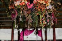 09 Look at this gorgeous floral explosion in deep red, pink, with cascading greenery, bulbs and lights