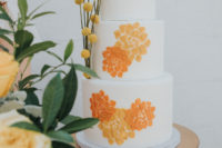 09 The wedding cake was a white one decorated with mustard and rust painted blooms
