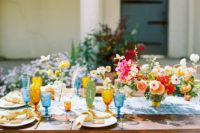 09 The wedding tablescape was done with a blue table runner, colored glasses, bright florals and cacti