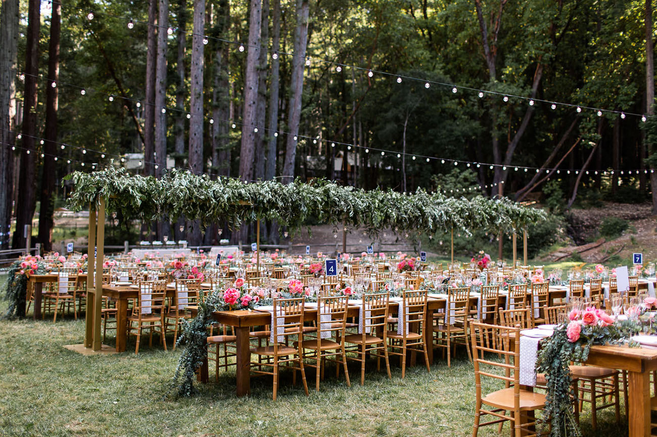 The wedding reception took place outdoors, with lights and greenery over the tables