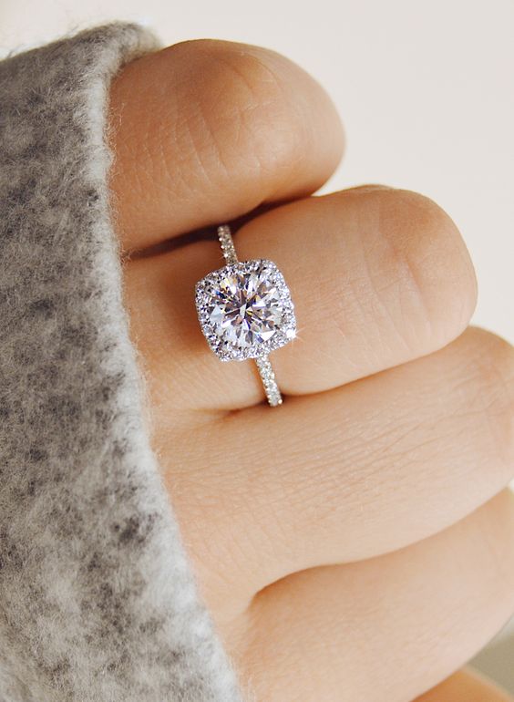 a delicate cushion shaped halo diamond engagement ring is a timeless and chic solution that many girls will like