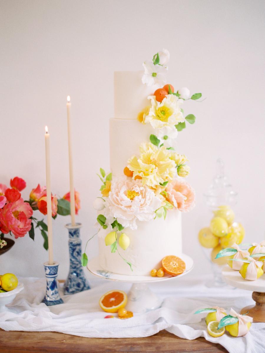 The wedding cake was a white one topped with edible sugar fruits and fresh blooms