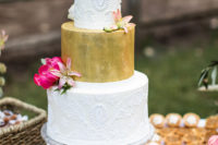 12 The wedding cake was whimsy, with a gold and white lace tiers, an arrow topper and pink blooms