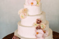 13 The wedding cake was white and textural, decorated with mauve and pink blooms