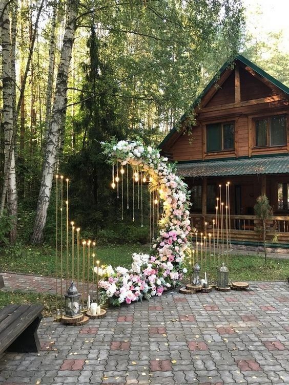 a moon wedding ceremony altar with bulbs, lights around and lush pink and white blooms all over