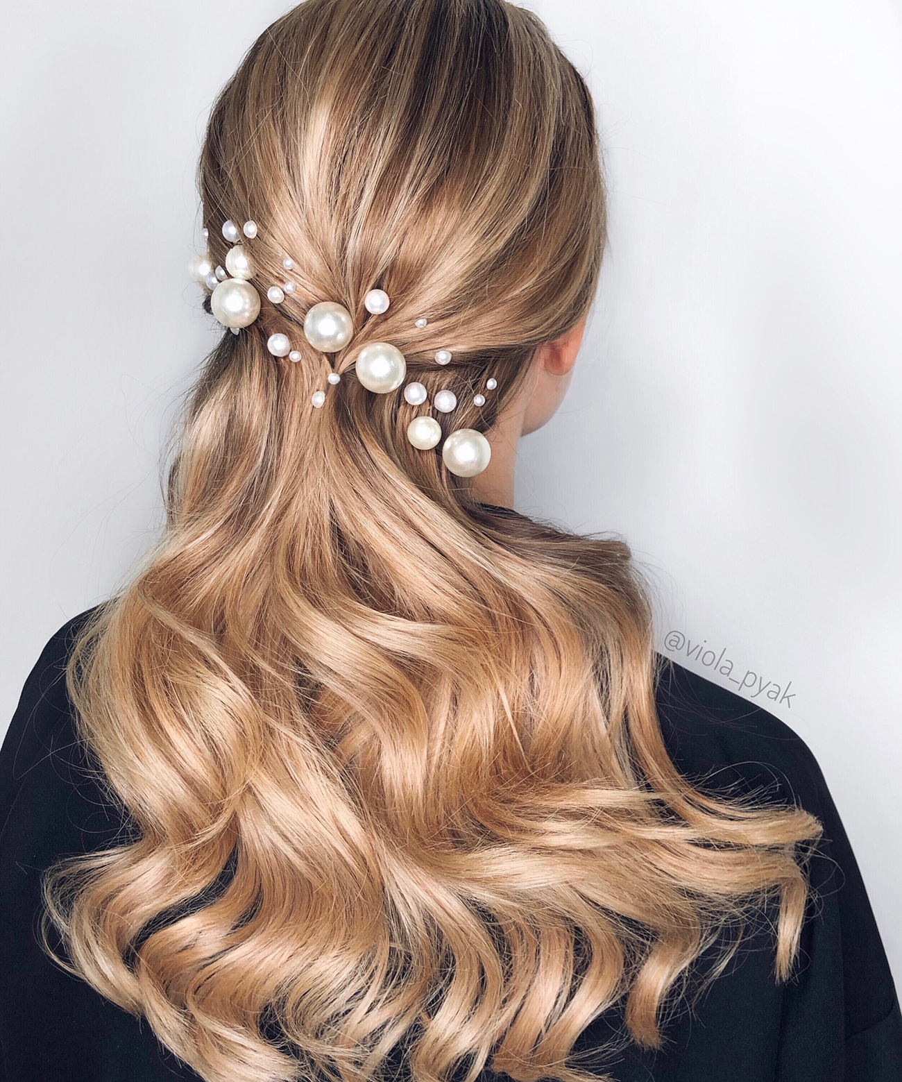 Swept back wavy hair with assorted pearl pins looks very chic, refined and makes a stylish statement