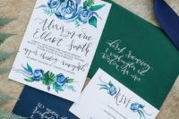 14 a beautiful navy and green wedding invitation suite with painted blue flowers and a silk ribbon
