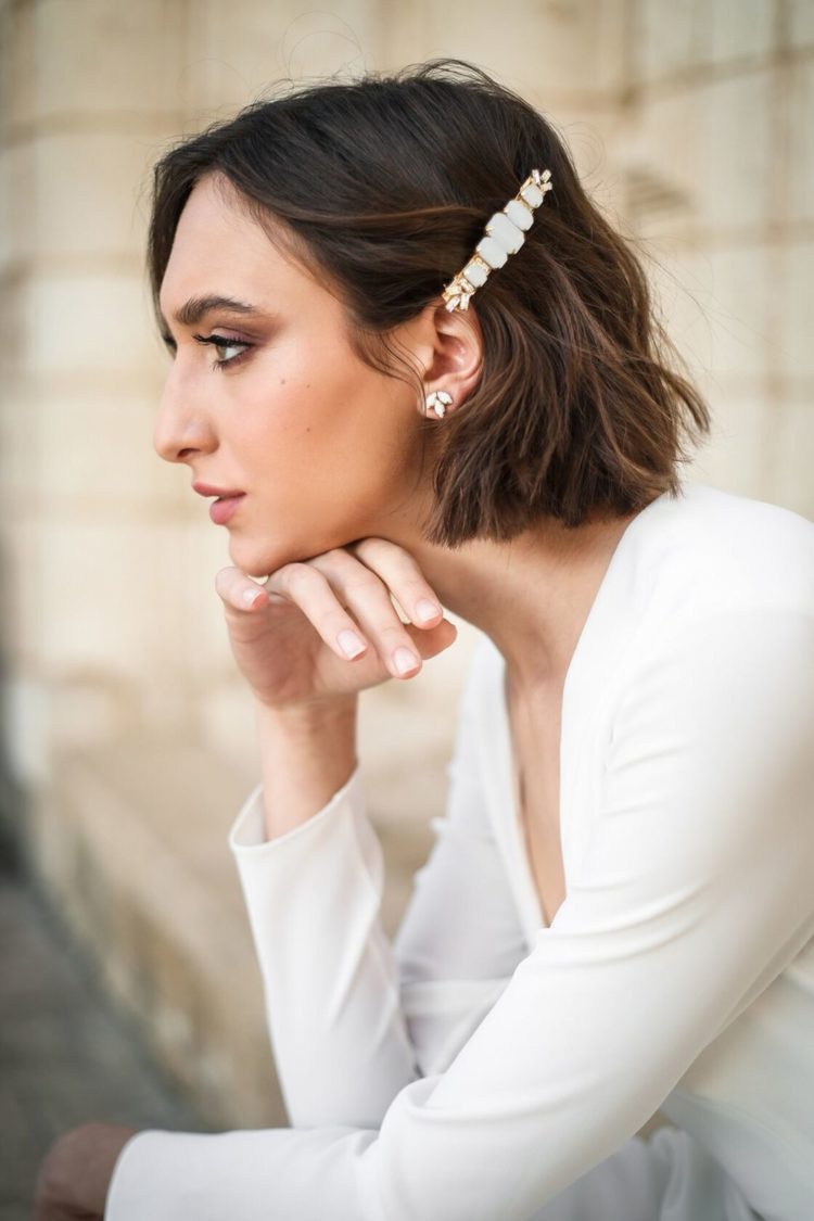 an elegant modern barrette with white rhinestones and gold plus matching stud earrings for a modern bride
