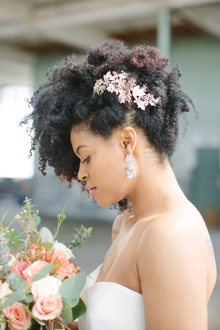 natural curls raised up and accented with gold flowers looks veyr refined, chic and bold