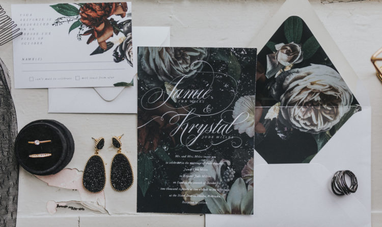 The wedding invitation suite was done with moody florals and white calligraphy