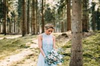 02 a beautiful blue A-line wedding dress with a lace bodice, no sleeves and a layered skirt with a train