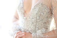 04 a beautiful silver fully embellished wedding dress with a deep V-neckline and matching earrings