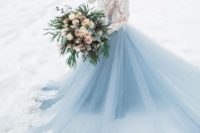 06 a breathtaking wedding dress with a white lace bodice and a blue skirt with white lace and a train