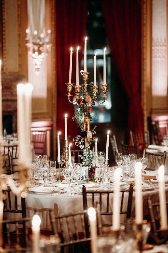 Tall and large candelabras decorated with bright blooms and greenery were used as centerpieces