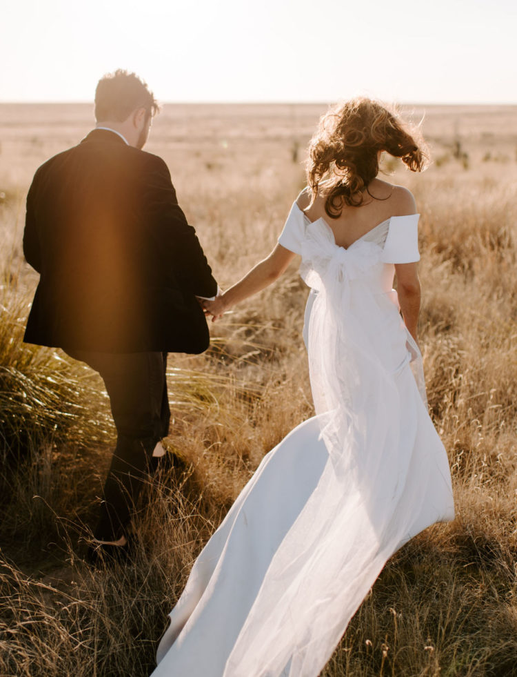 The couple went for a walk and portraits in the desert, look at the gorgeous wedding dress