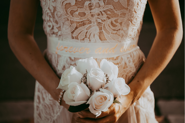 The wedding bouquet was composed of white roses and lavender to make it cuter