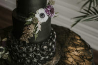 07 The wedding cake was a black one, with gold leaf and fresh blooms and greenery