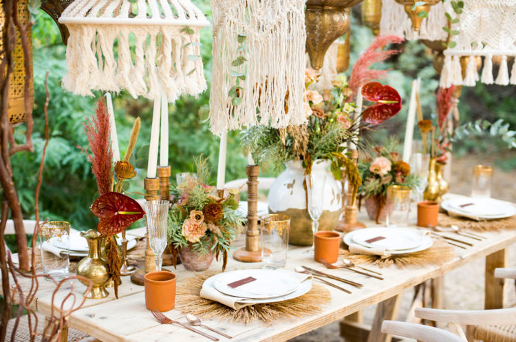 Candles, dried herbs and blooms, pampas and terracotta cups create a boho feel at the table