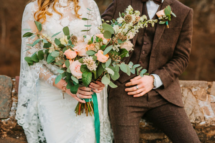 The wedding bouquet was done with peachy blooms and greenery and emerald ribbons