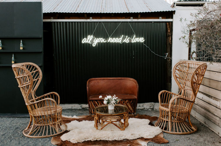 The wedding lounge was done with chic rattan furniture, blooms and layered rugs
