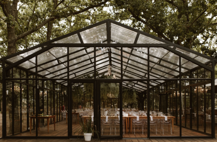 The wedding reception took place in a glasshouse that was opened to outdoors as much as possible