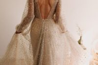 09 a tan fully embellished wedding gown with an open back, a train and a V-neckline