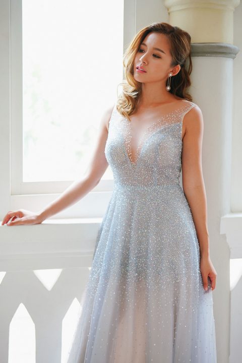 a light blue fully embellished wedding dress with an illusion neckline and no sleeves