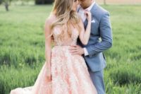 10 a pink sleeveless wedding dress with a trendy plunging neckline and pearl floral embroidery all over the gown