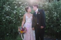 11 a pink spaghetti strap wedding dress with floral appliques and embroidery plus a highlighted waistline
