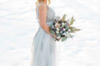 12 an icy blue sleeveless winter wedding dress with a lace bodice, a tulle and lace skirt is very delicate and chic
