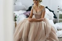 20 a dusty pink off the shoulder wedding dress with cap sleeves, a deep cut neckline and a layered skirt