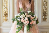 21 a gorgeous pink princess style wedding dress with a plunging neckline, beading and white floral lace appliques