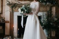 21 a romantic A-line wedding dress with a lace bodice, illusion sleeves and a neckline plus a high low skirt with a train