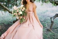 22 a pink silk A-line wedding gown with thick straps and a plunging neckline is ultra-modern yet very romantic
