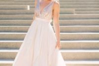 23 a sleeveless light pink wedding gown with a sequin bodice and a plain full skirt, a plunging neckline