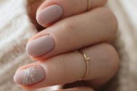 30 shiny blush wedding manicure and the ring finger accented with white and gold glitter for a winter bride