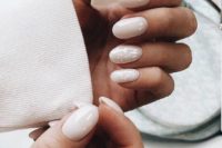 31 shiny white nails and two accent ones with a touch of mother of pearl look very feminine and chic