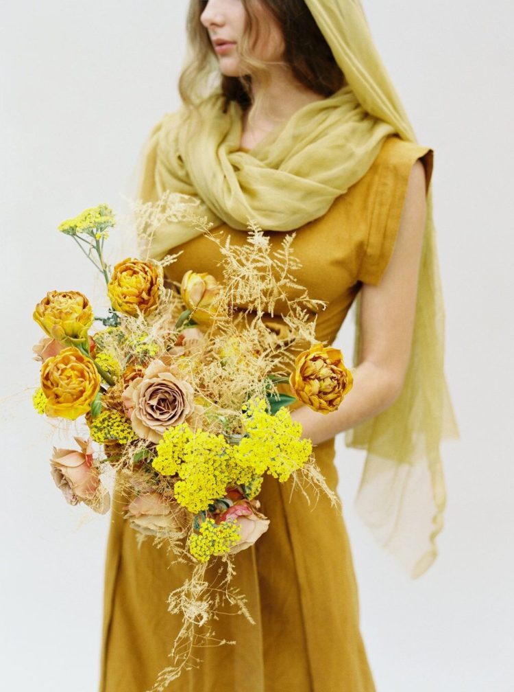 a bold mustard wedding bouquet with fresh and dried blooms and herbs is amazing for a fall bride