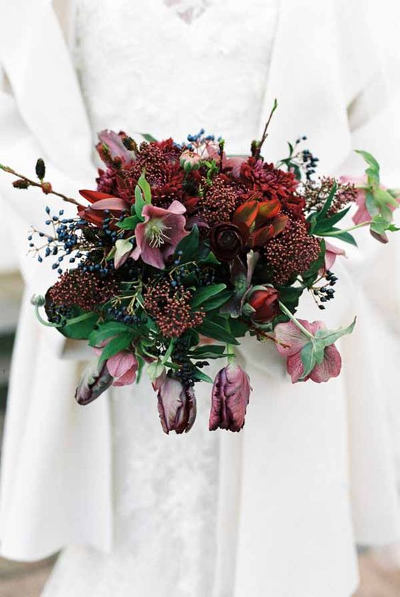 a burgundy wedding bouquet with mauve blooms and privet berries is a stylish option for a winter wedding