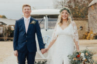 02 The bride was wearign an A-line boho lace wedding dress with a front slit and a greenery crown, the groom was wearing a navy suit with a blush tie