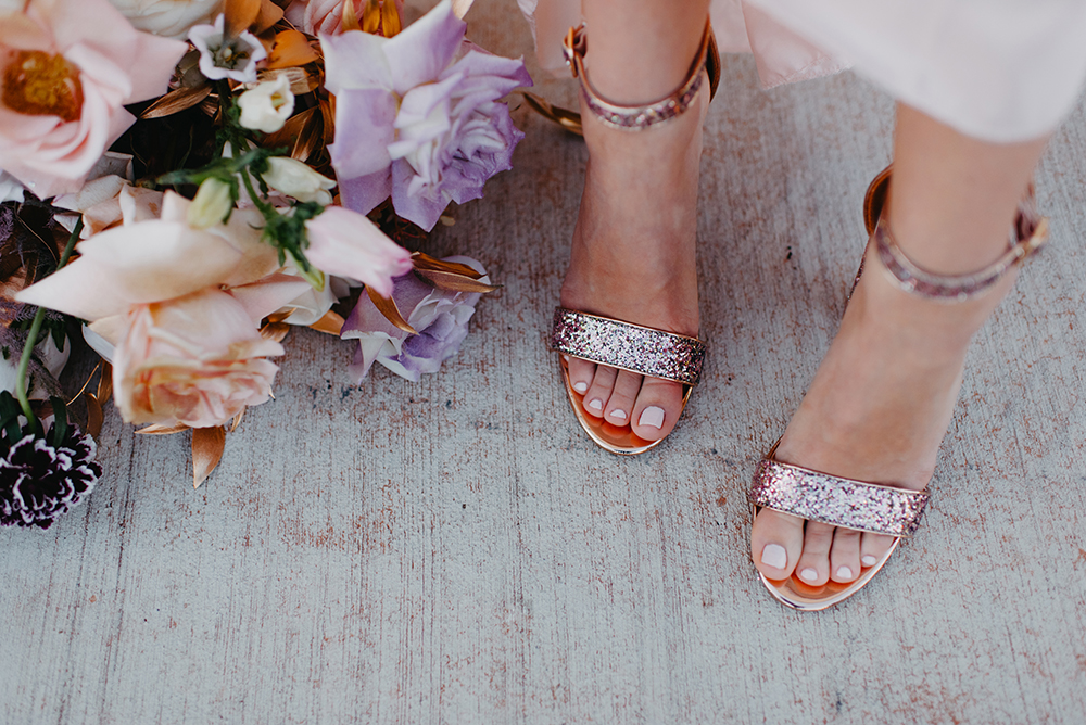 The bride was wearing rose gold glitter wedding shoes