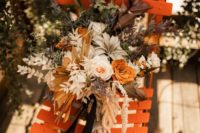 02 The wedding bouquet was done with rust-colored and blush blooms, greenery and air plants