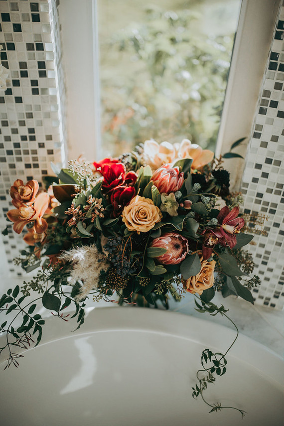 Her wedding bouquet was a moody one, with privet berries and textural greenery