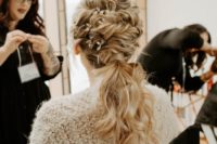 03 The bride was rocking a twisted and wavy low ponytail accented with rhinestone hairpieces