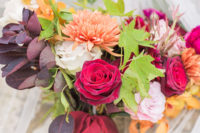 03 The wedding bouquet was done with deep red, orange, blush and white blooms, greenery and dark foliage