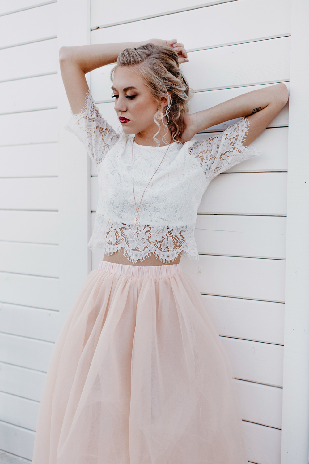 Her wedding ensemble was a white lace crop top and a blush maxi skirt