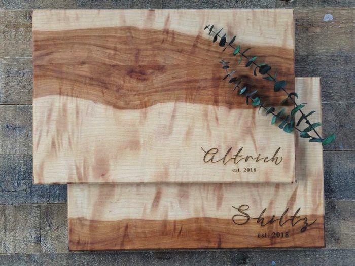 a set of custom engraved cutting boards is a stylish idea, especially if you choose a set that shows off the wood texture and structure