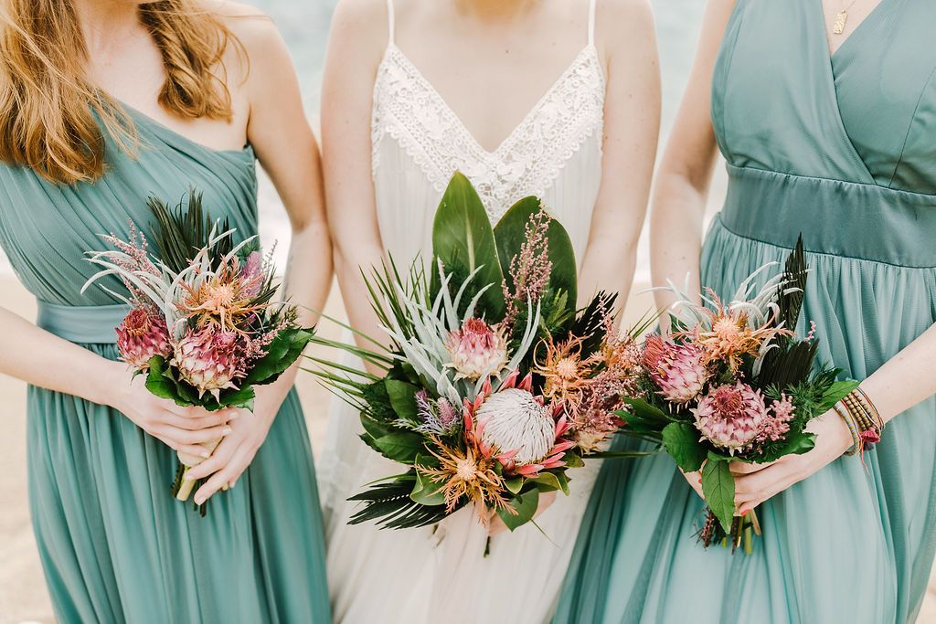 All the girls were carrying tropical bouquets with king proteas, tropical foliage and succulents