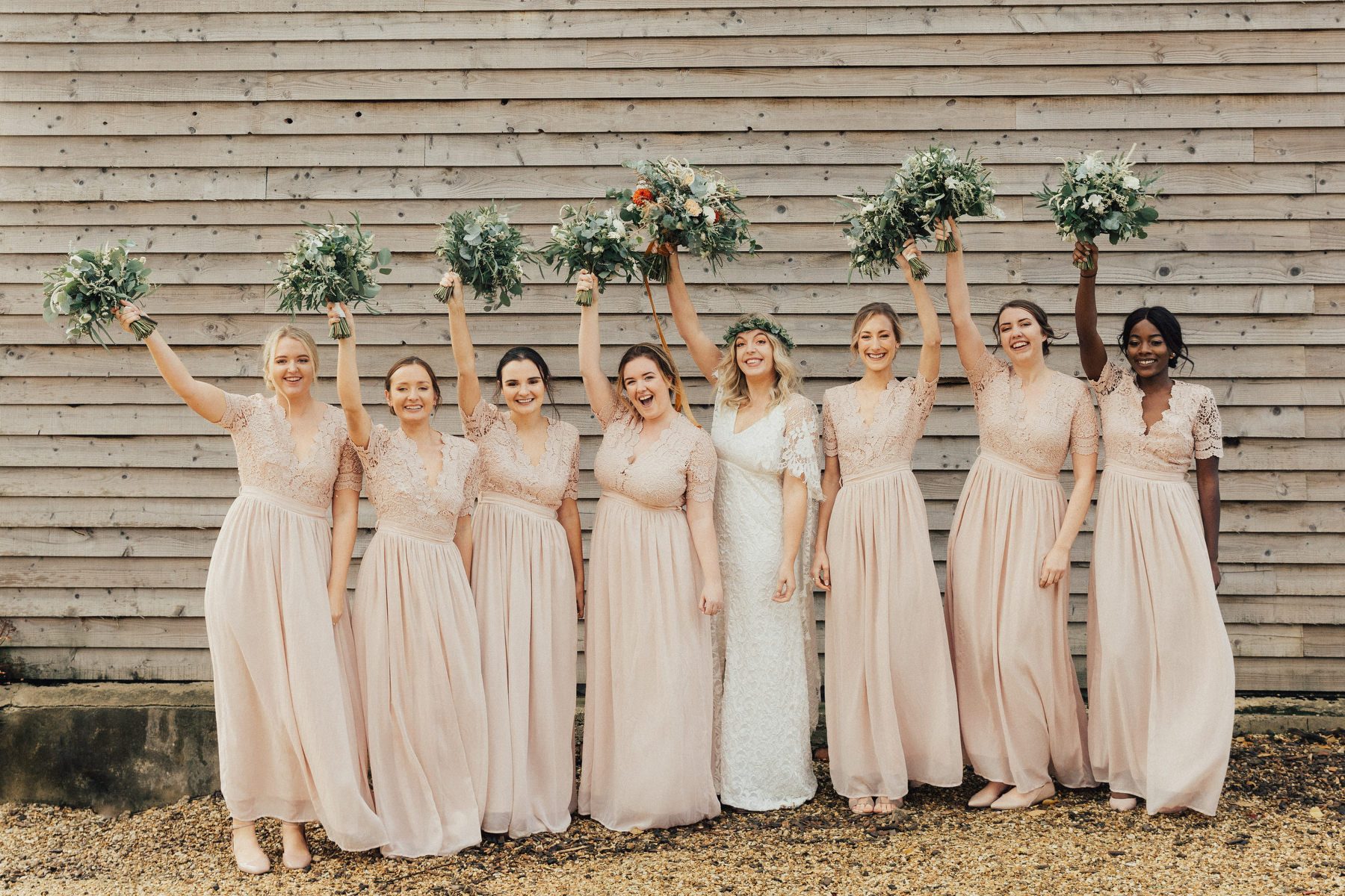 The bridesmaids were wearign matching blush maxi dresses with lace bodices